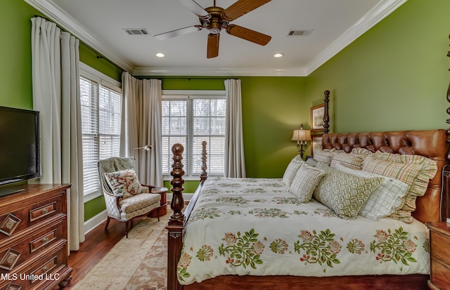 bedroom featuring ceiling fan, ornamental molding, and light wood-type flooring