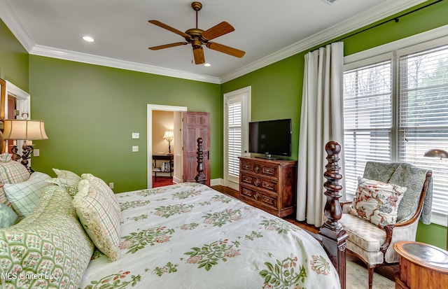 bedroom featuring ceiling fan, wood-type flooring, and ornamental molding