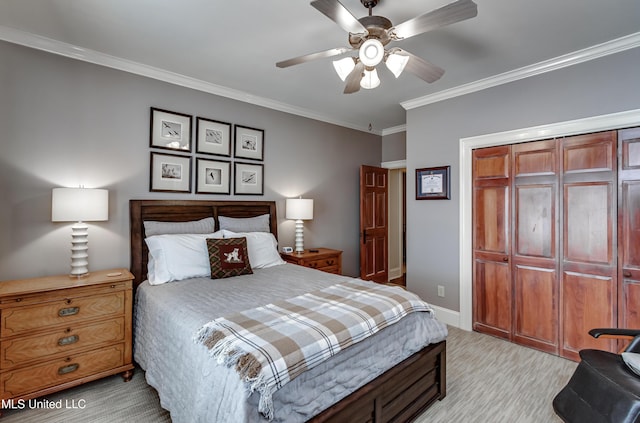 bedroom featuring ceiling fan, a closet, and crown molding