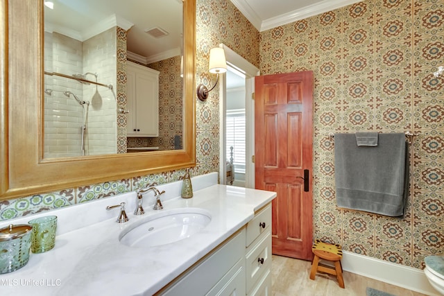 bathroom with vanity, a shower, ornamental molding, and hardwood / wood-style flooring