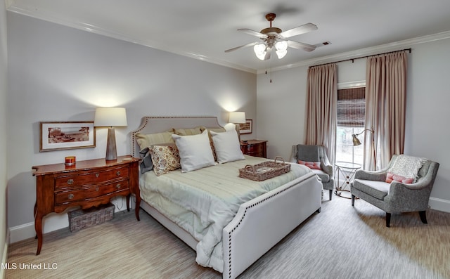 bedroom with ceiling fan and ornamental molding