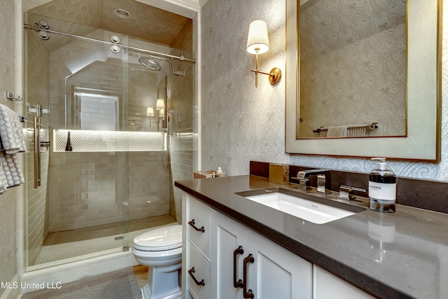 bathroom featuring an enclosed shower, vanity, and toilet