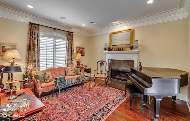 sitting room with crown molding and hardwood / wood-style floors