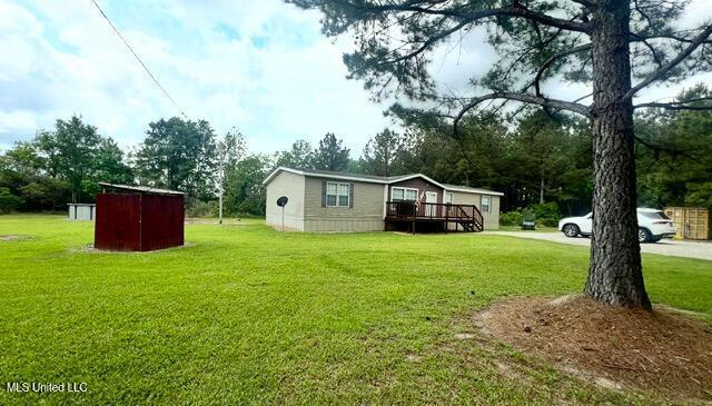 exterior space featuring an outdoor structure and a deck