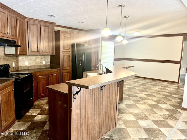 kitchen with a sink, under cabinet range hood, black appliances, tile patterned floors, and a center island with sink