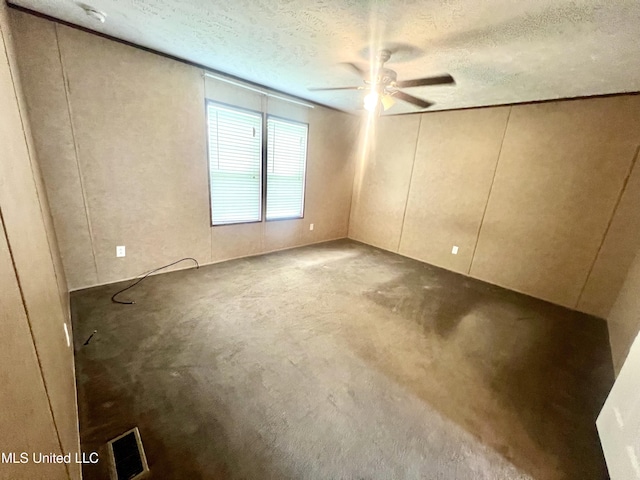 unfurnished room featuring a textured ceiling, visible vents, and ceiling fan