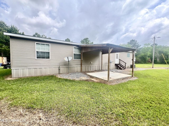 back of property featuring a lawn, a patio, and entry steps