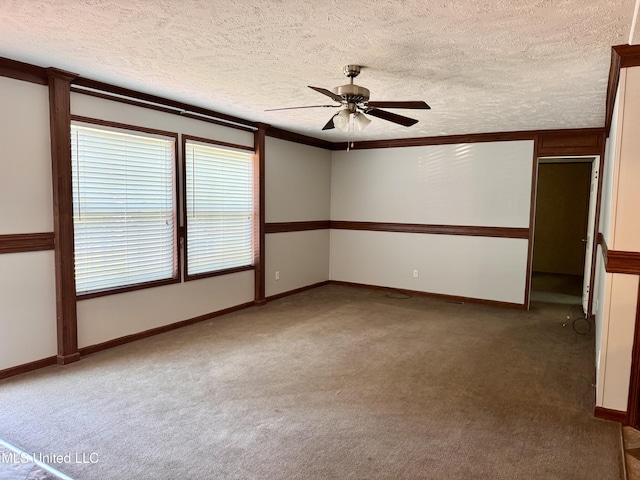 unfurnished room with a ceiling fan, baseboards, carpet floors, and a textured ceiling