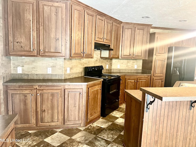 kitchen featuring under cabinet range hood, brown cabinets, stainless steel fridge with ice dispenser, and black electric range oven