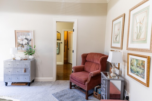 sitting room featuring carpet floors and baseboards