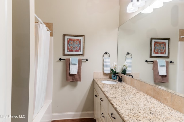 bathroom with baseboards and vanity