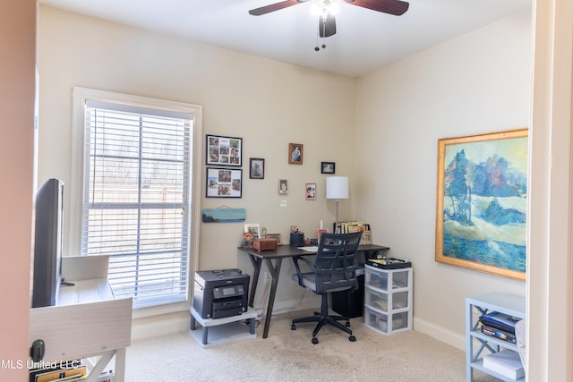 carpeted home office featuring ceiling fan and baseboards