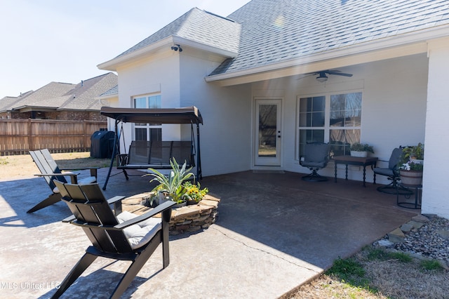 view of patio / terrace featuring ceiling fan and fence