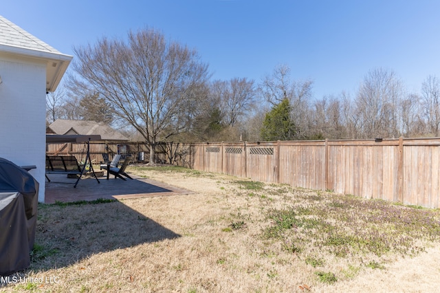 view of yard with a patio area and a fenced backyard