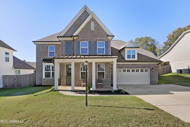 view of front of home with a front lawn, a garage, and a porch