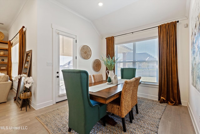 dining area featuring a wealth of natural light, light wood-type flooring, and lofted ceiling