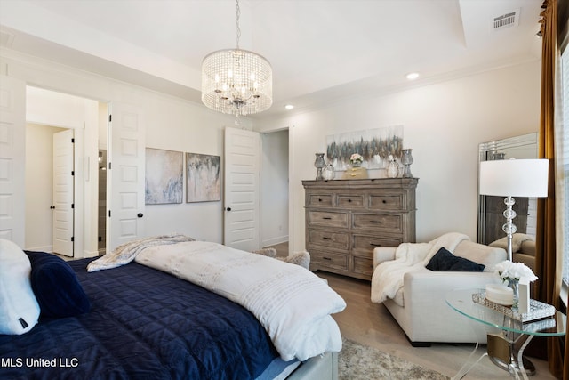 bedroom with hardwood / wood-style floors, a chandelier, and ornamental molding