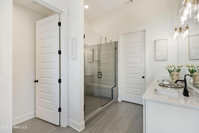 bathroom with walk in shower, vanity, and crown molding