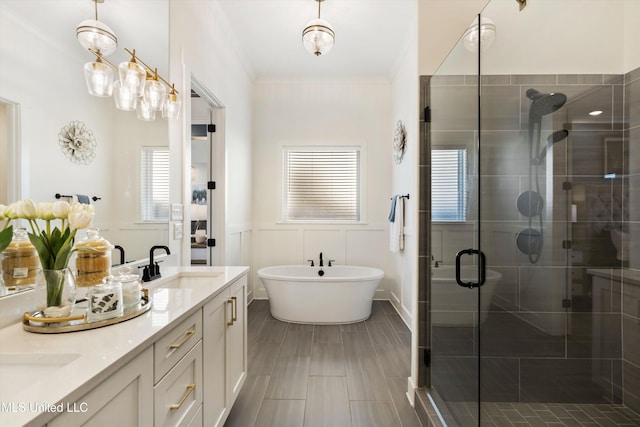 bathroom with ornamental molding, shower with separate bathtub, and vanity