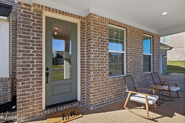 doorway to property featuring covered porch