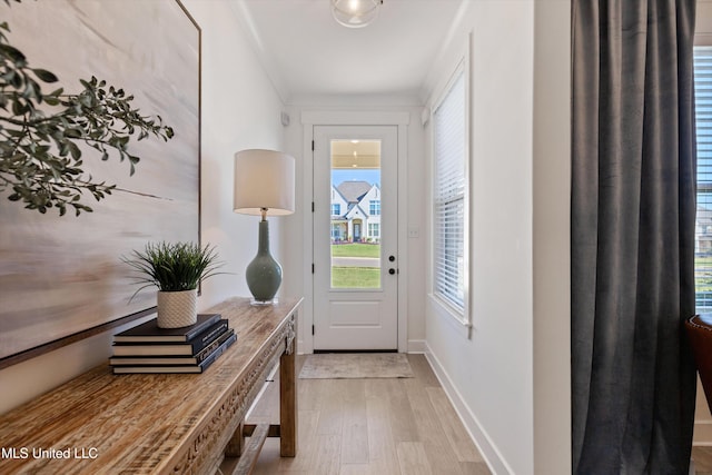 entryway featuring light hardwood / wood-style floors and ornamental molding