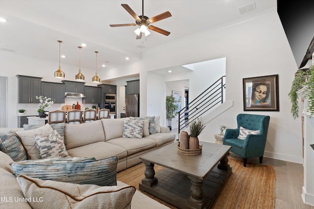 4975 Longmire Ln, Olive Branch, MS 38654 - living room with a ceiling fan, light wood-style floors, stairway, recessed lighting, and baseboards
