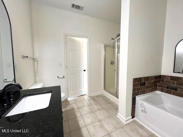 full bathroom with tile patterned flooring, toilet, independent shower and bath, and sink