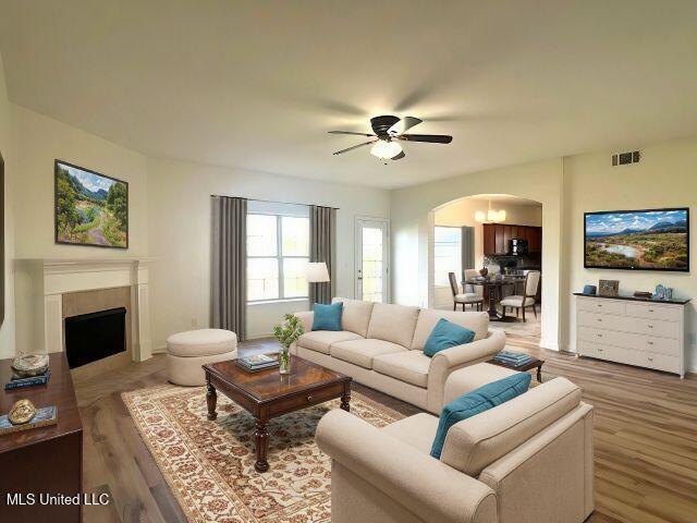 living room with hardwood / wood-style flooring and ceiling fan