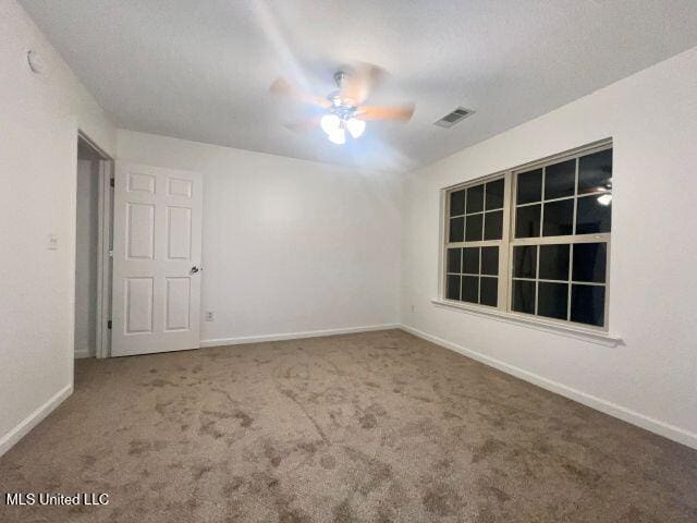 carpeted empty room with ceiling fan