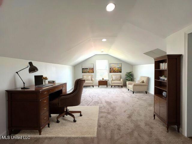 office space with light colored carpet and lofted ceiling