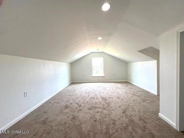 additional living space with lofted ceiling and carpet floors