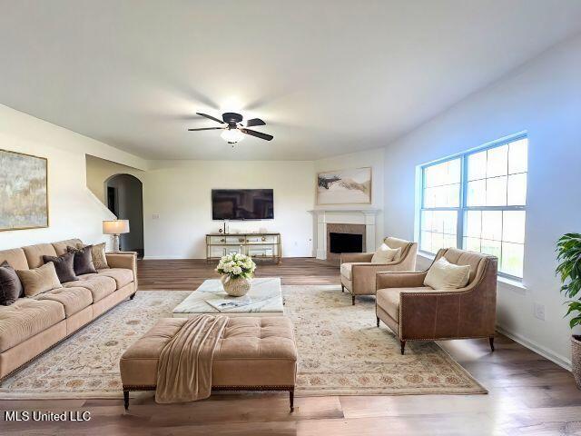 living room featuring hardwood / wood-style floors and ceiling fan