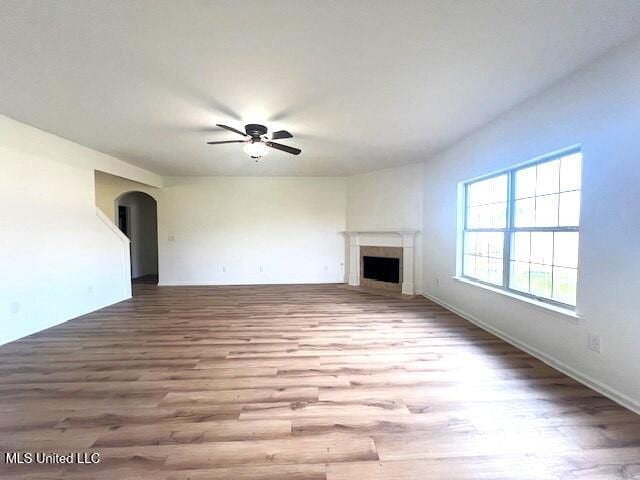 unfurnished living room featuring light hardwood / wood-style flooring and ceiling fan