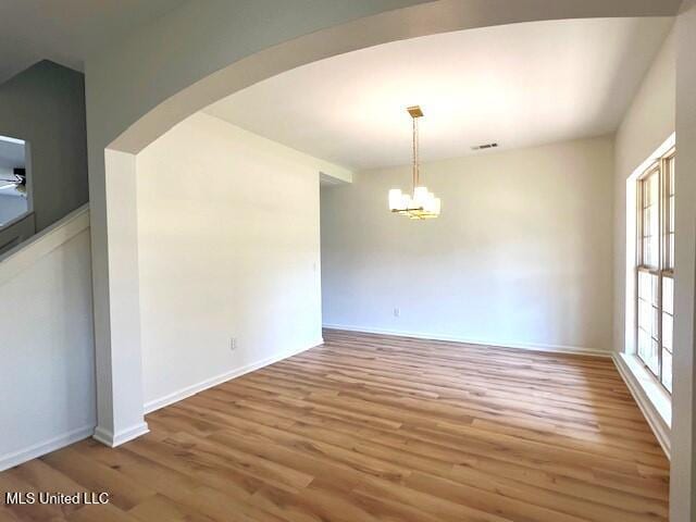 interior space featuring wood-type flooring and an inviting chandelier