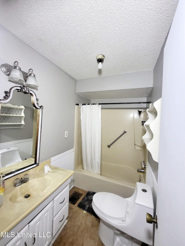 98 Danny Ln, Sardis, MS 38666 - full bathroom with vanity, toilet, shower / bathtub combination with curtain, a textured ceiling, and tile patterned flooring