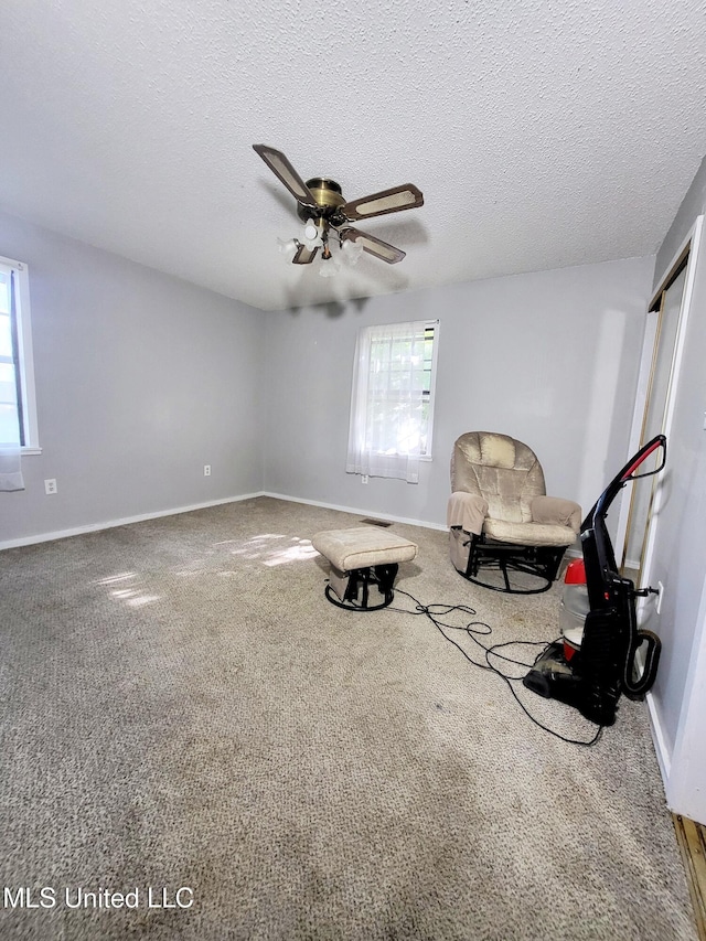 98 Danny Ln, Sardis, MS 38666 - sitting room featuring ceiling fan, carpet floors, baseboards, and a textured ceiling