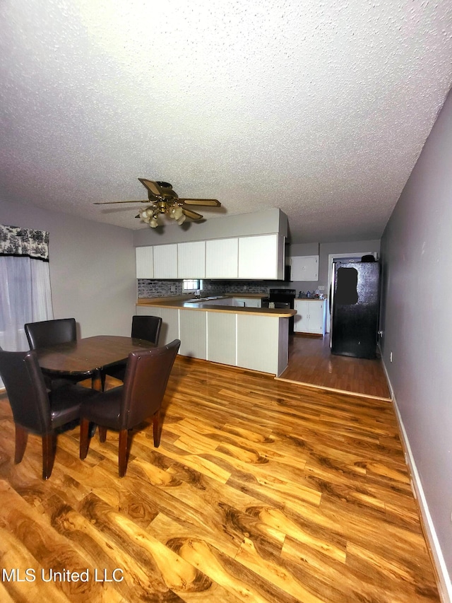 98 Danny Ln, Sardis, MS 38666 - dining space featuring a textured ceiling, ceiling fan, wood finished floors, and baseboards