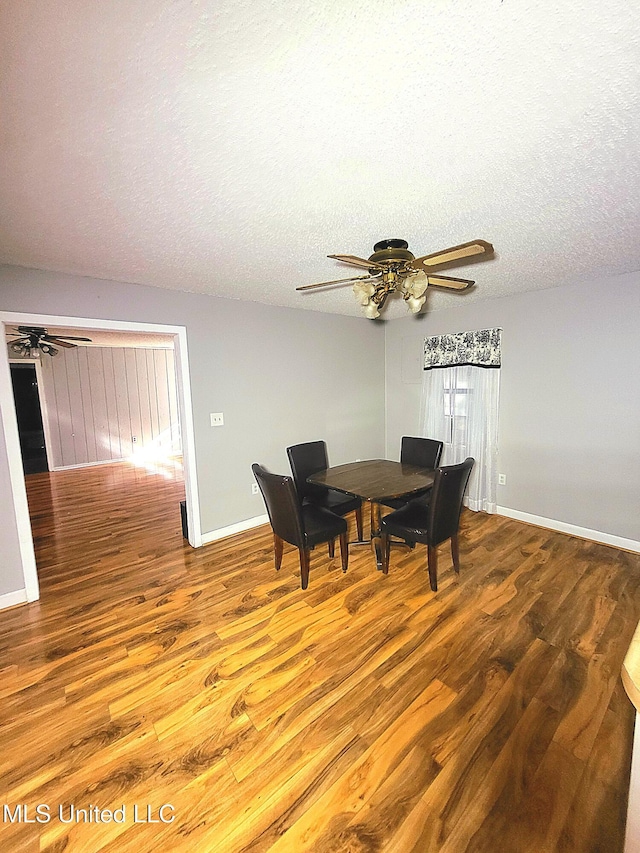 98 Danny Ln, Sardis, MS 38666 - dining area featuring ceiling fan, wood finished floors, baseboards, and a textured ceiling