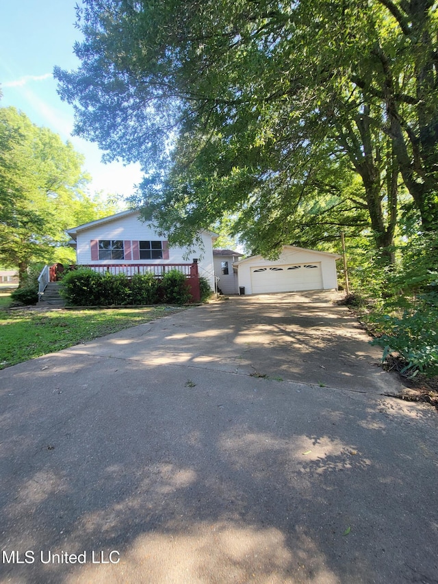 98 Danny Ln, Sardis, MS 38666 - view of front of house with an outbuilding, asphalt driveway, and a garage