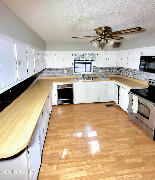 98 Danny Ln, Sardis, MS 38666 - kitchen featuring black appliances, a sink, light wood-type flooring, tasteful backsplash, and a textured ceiling