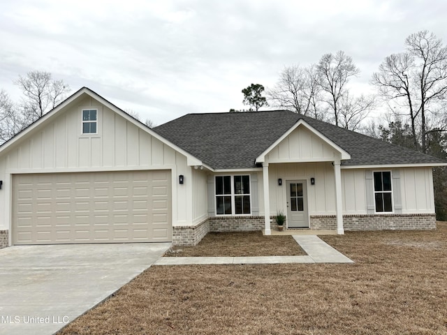 view of front of property with a garage and a front yard