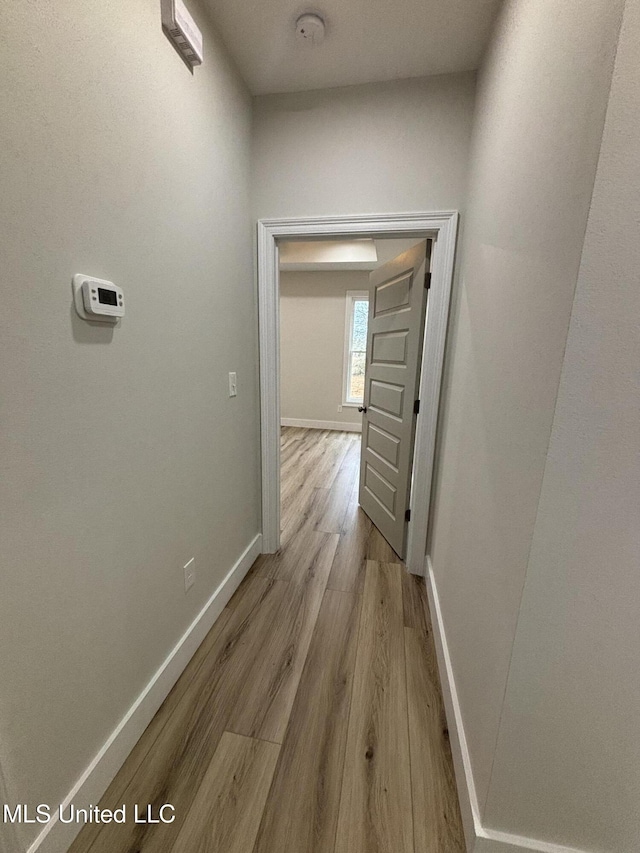 corridor with light hardwood / wood-style flooring