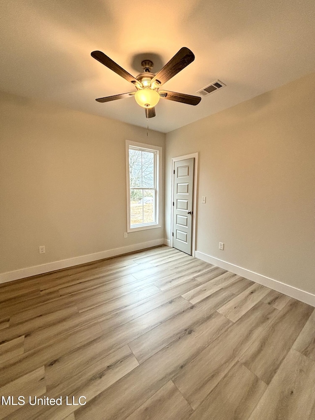 empty room featuring ceiling fan and light hardwood / wood-style floors