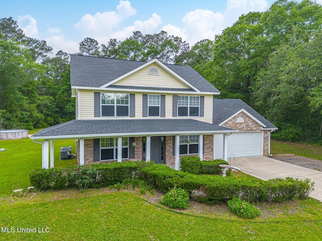 view of front of house with roof with shingles, driveway, a porch, a garage, and a front yard