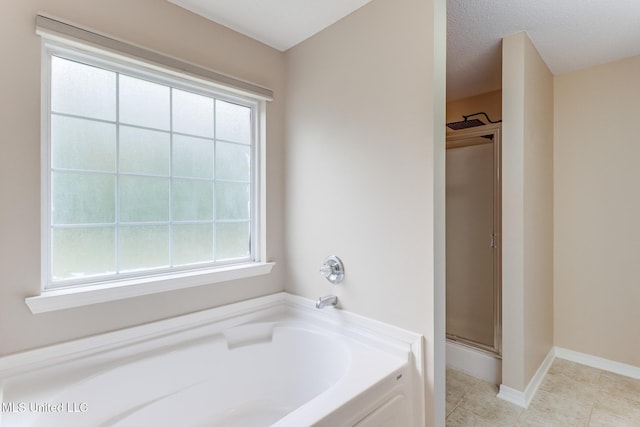 bathroom with a bath, tile patterned floors, and a shower stall