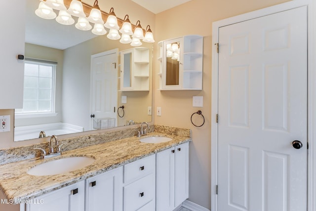 full bath featuring a washtub, a sink, and double vanity