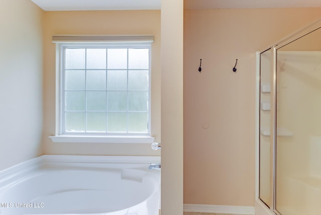 bathroom with a bath and a shower stall