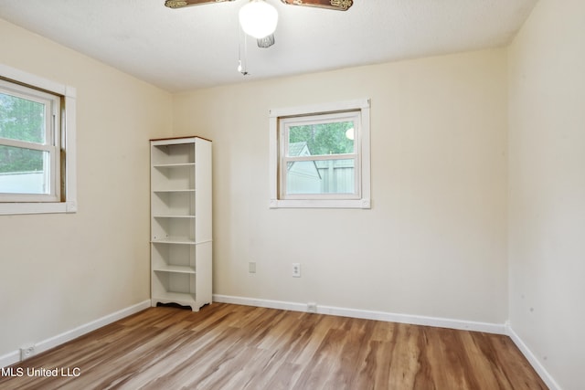 empty room featuring a textured ceiling, light hardwood / wood-style floors, and ceiling fan