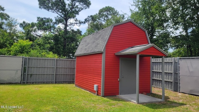 view of outbuilding with a yard