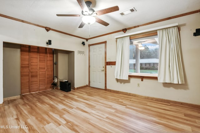 empty room featuring crown molding, ceiling fan, and light hardwood / wood-style floors